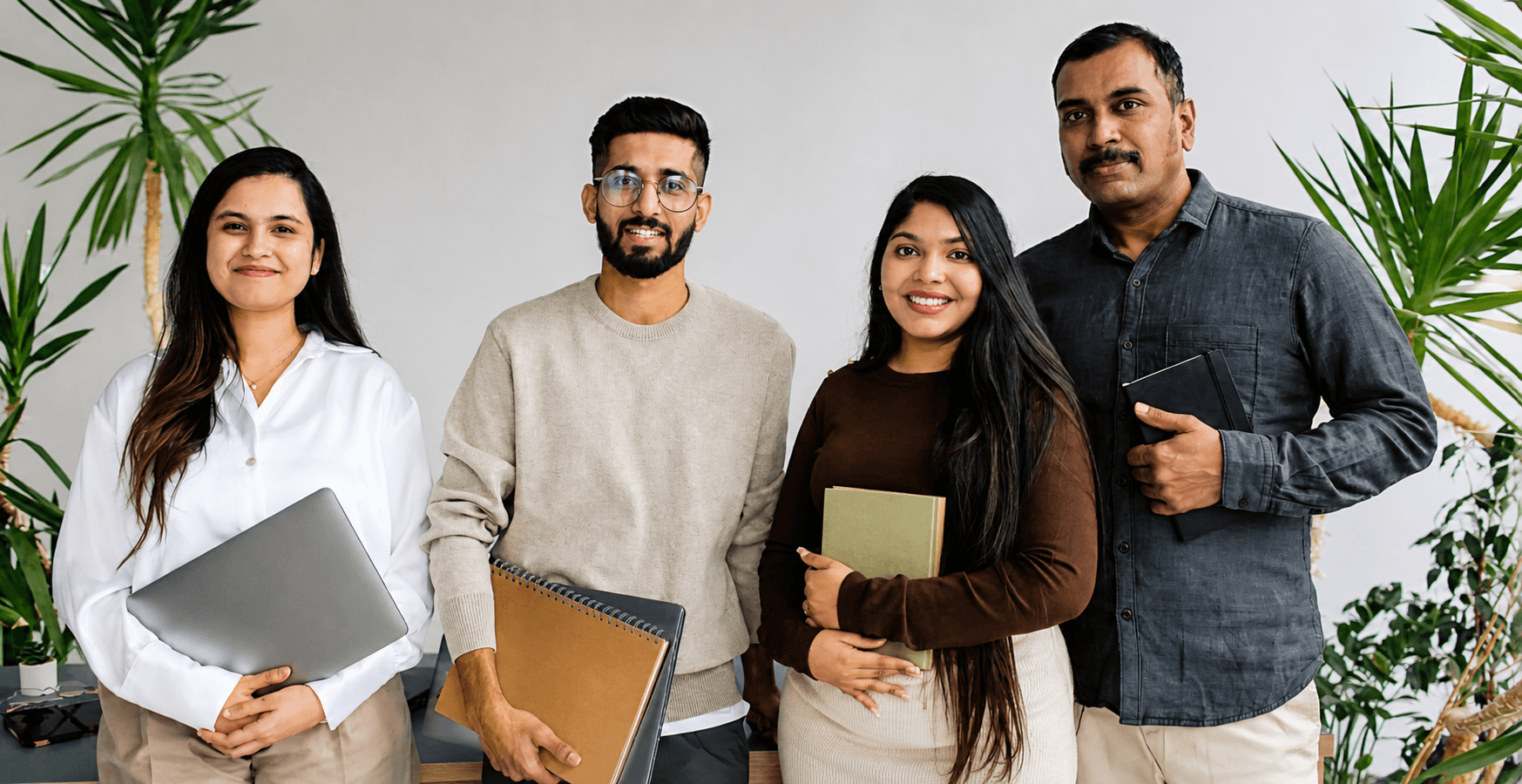 Four accessibility professionals standing together in an office environment representing inclusive workforce and accessibility consulting services